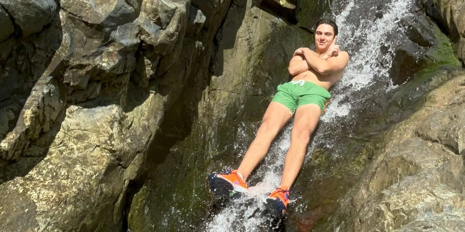 A guest lying back in the flow of the natural rock waterslide